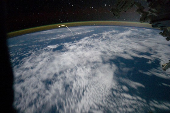 The space shuttle Atlantis, appearing like a bean sprout against clouds and city lights, on its way home, as photographed by the Expedition 28 crew of the International Space Station on Thursday, July 21. Airglow over Earth can be seen in the background. The Atlantis returned to Earth marking the end of the space shuttle era when its wheels touched down for the last time at the Kennedy Space Center.