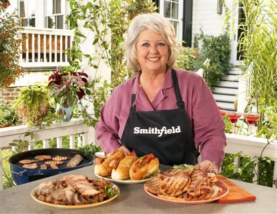 FILE - This undated image released by Smithfield Foods shows celebrity chef Paula Deen wearing a Smithfield apron as she stands in front of various Sm...