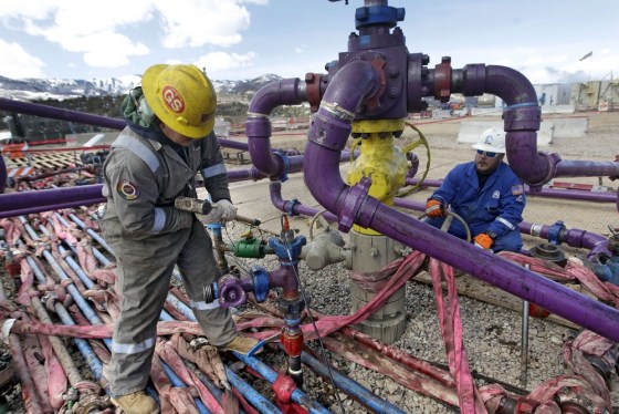 In this March 29, 2013 photo, workers tend to a well head during a hydraulic fracturing operation at an Encana Oil & Gas (USA) Inc. gas well outside R...