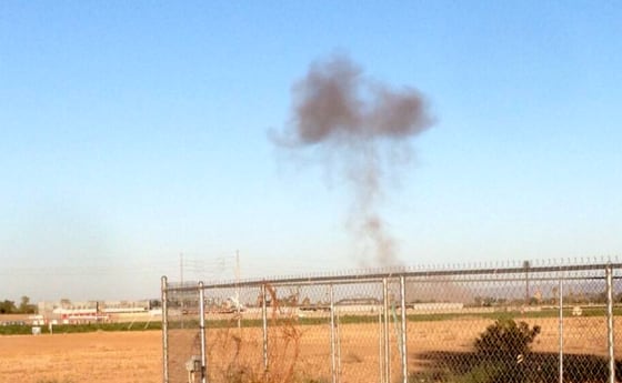 Smoke rises from the scene of an F16 fighter jet crash Wednesday, June 26, near Glendale, Ariz.
