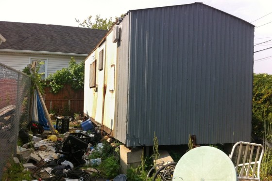 A dilapidated trailer sits up on blocks in a trash strewn lot in the Queens borough of New York, Tuesday, June 15, 2013. Thought to be vacant, the trailer went unsearched after Superstorm Sandy flooded the area in late 2012. More than five month after the storm, the partially skeletonized remains of 62-year-old Keith Lancaster were found inside on April 5, 2013.