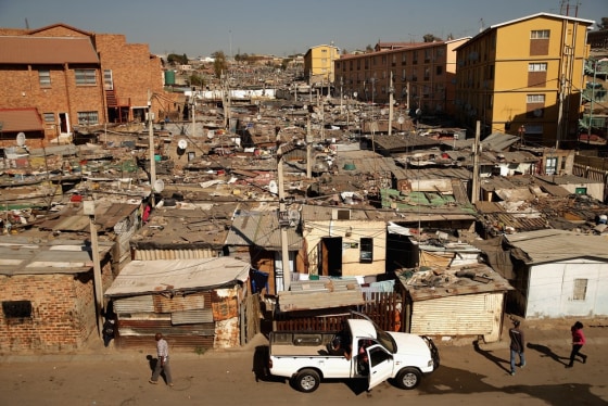 Built in a haphazard swath, shacks stretch on to the horizon in Alexandra Township on June 26, in Johannesburg, South Africa. Alexandra is situated next to the wealthy suburb of Sandton, laying bare post-apartheid South Africa's vast gulf between wealth and poverty.