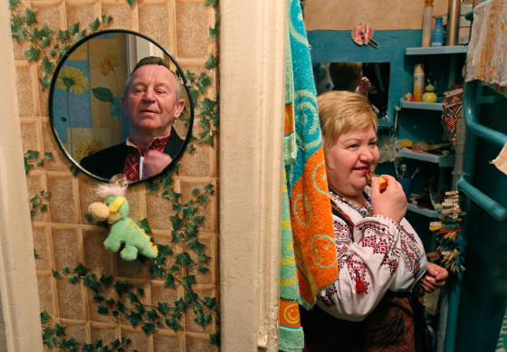 Mykola Milevsky, 75, left, and Natalia Stolyarenko, 58, stand in their apartment as they prepare to attend an amateur dance gathering in Kiev, Ukraine, Feb. 24.