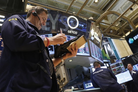 Traders work on the floor of the New York Stock Exchange, March 4, 2013.