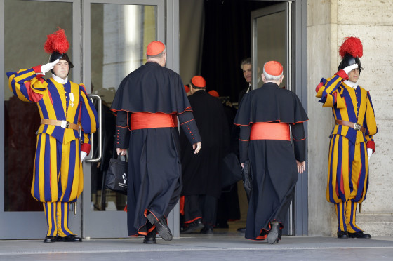 Vatican Swiss guards salute as cardinals arrive for a meeting at the Vatican on March 4.