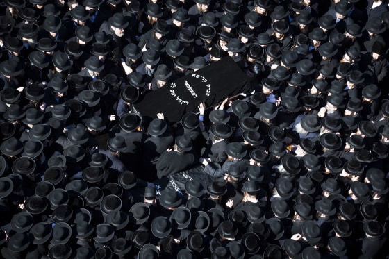 Members of the Satmar Orthodox Jewish community carry caskets Sunday to the funeral of two expectant parents who were killed in a car accident in Brooklyn, N.Y.