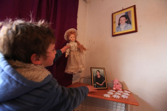 Marsela, 9, plays with her doll at her home in northwestern Albania.