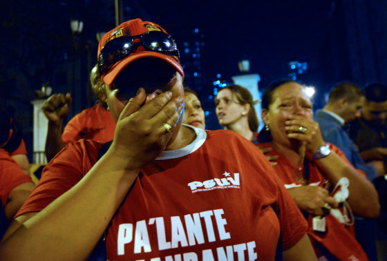 Supporters of Venezuelan President Hugo Chavez gather in front of Miraflores presidential palace in Caracas on Tuesday night, after knowing of their leader's death.