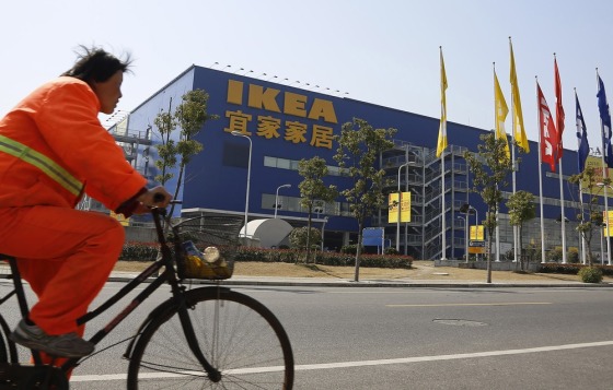 A public worker rides a bicycle in front of an Ikea shop on March 6 in Shanghai, China. Chinese authorities say they have destroyed nearly two tons of chocolate cake imported by Sweden's Ikea for violating food quality standards.