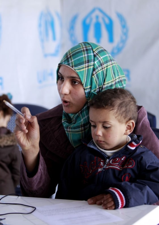 Refugee Bushra, 19, who fled her home in Syria 17 days ago, holds her son Omar, 2, as she registers at the UNHCR center in the northern city of Tripoli, Lebanon, Wednesday. She was declared the millionth refugee to leave the country.