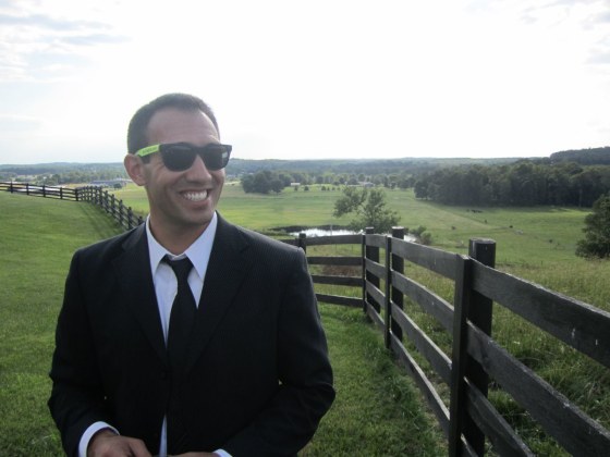 Mike Hrostoski smiles in a field.