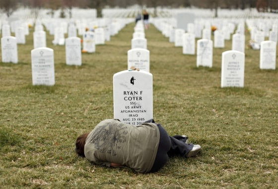 Lesleigh Coyer, 25, of Saginaw, Michigan, lies down in front of the grave of her brother, Ryan Coyer, who served with the U.S. Army in both Iraq and Afghanistan, at Arlington National Cemetery in Virginia on March 11, 2013. Coyer died of complications from an injury sustained in Afghanistan.