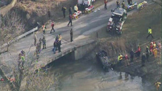 Emergency personnel at the scene where a car crashed into a creek in Illinois, killing four teens.