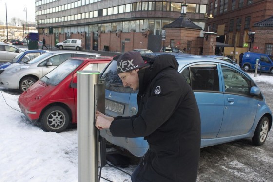 Are Paulsrud disconnects his electric car from a free recharging station in Oslo February 21, 2013.