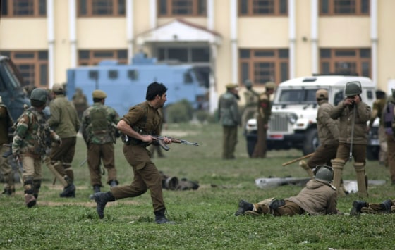 Indian policemen and paramilitary soldiers react during a gunbattle in Srinagar on March 13, 2013.
