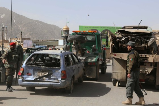 Afghan security officials inspect the scene of a suicide bomb attack outside the Afghan Defense Ministry Saturday. Hamid Karzai suggested the Taliban and U.S. colluded over the attack in order to persuade people that foreign forces had to stay in the country.
