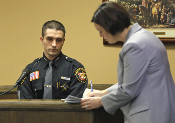 Jefferson County Deputy Sherriff A. Ellenberger, left, listens as prosecuting attorney Marianne Hemmeter asks questions during a rape trial in juvenile court on Thursday in Steubenville, Ohio.