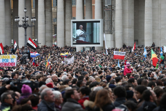 Crowds fill St. Peter's Square as live footage of Pope Francis is projected on a giant screen on March 17.