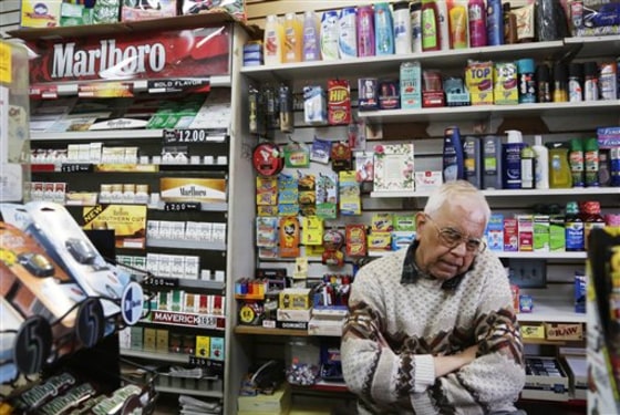 Harry Patel, an employee of Blondie's Deli and Grocery, talks on the phone while waiting for customers in New York on Monday. A new anti-smoking proposal would make New York the first city in the nation to keep tobacco products out of sight in retail stores. Mayor Michael Bloomberg says the goal is to reduce the youth smoking rate.
