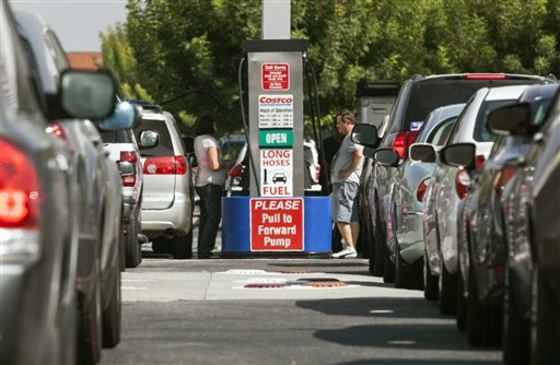 FILE - In this Friday, Oct. 5, 2012, file photo, Costco members fill up with discounted gasoline at a Costco gas station in Van Nuys, Calif. U.S. oil...