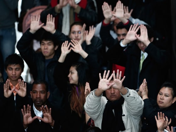 Members of the group Casa In Action demonstrate for immigration reform in the Hart Senate Office Building March 21, 2013 in Washington, DC.