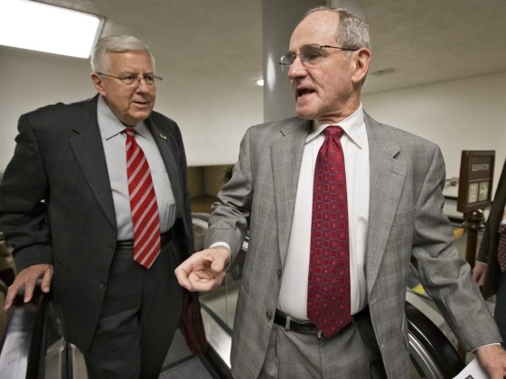 Sen. Jim Risch, R-Idaho, right, turns to Sen. Michael B. Enzi, R-Wyo., as lawmakers rush to the Senate floor on Capitol Hill in Washington, Friday, March 22, 2013, to vote on amendments to the budget resolution.