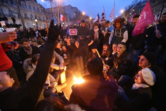 Demonstrators sing around a fire during a protest on the Champs-Elysees avenue in Paris on March 24, 2013 against France's gay marriage law in an attempt to block legislation that will allow homosexual couples to marry and adopt children.