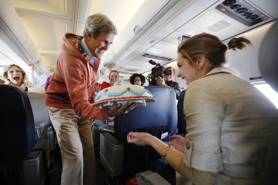 U.S. Secretary of State John Kerry presents a birthday cake to CBS correspondent Margaret Brennan on his flight from Kabul to Paris on March 26. Kerry held a second round of talks with Afghan President Hamid Karzai in Kabul on Tuesday after the two put on a public show of unity in a bid to repair damaged ties.