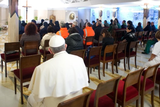 Pope Francis prays with Vatican employees before leading a mass at the Santa Martha chapel at the Vatican on March 23, 2013.
