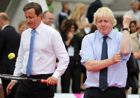 Britain's Prime Minister David Cameron and Mayor of London Boris Johnson warm up for a tennis match during the London Olympics.