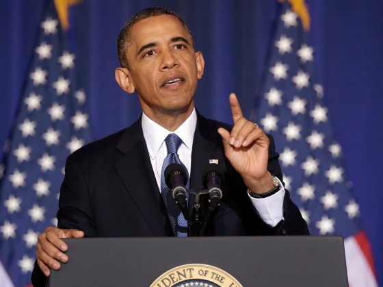 President Barack Obama tries to speak as Medea Benjamin, an activist from the organization called Code Pink, shouts at him while he spoke at the National Defense University May 23, 2013 in Washington, DC.