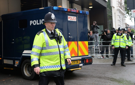 A police van carrying Michael Adebowale arrives at the Westminster Magistrates Court in London, Thursday.