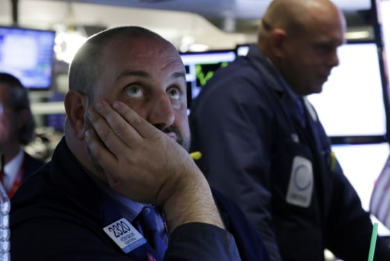 In this Wednesday, May 29, 2013, file photo, Specialist Peter Giacchi, left, works on the floor of the New York Stock Exchange.