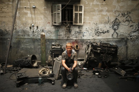 Apprentice mechanic Mohammed Yassin, 18, poses in an auto repair garage in Gaza City on May 30.