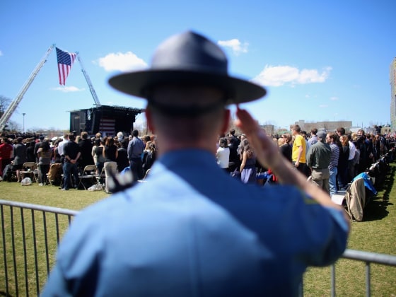 A Massachusetts State Police trooper salutes at the memorial service for slain Massachusetts Institute of Technology (MIT) police officer Sean Collier on April 24, 2013 in Cambridge, Massachusetts. Collier was allegedly shot by the suspects in the Boston Marathon bombing, Dzhokhar Tsarnaev, 19, and his brother Tamerlan Tsarnaev, 26,