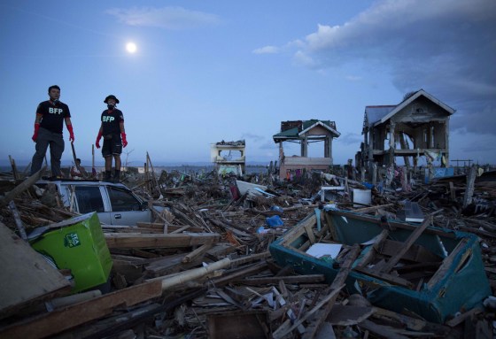 Philippines rescue workers search for bodies in the rubble in Tacloban on Saturday.