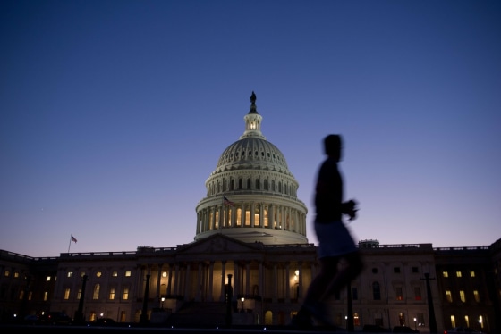 A man jogs past the US Capitol in Washington on September 30, 2013. The federal bureaucracy officially began a shutdown as of midnight, further damag...