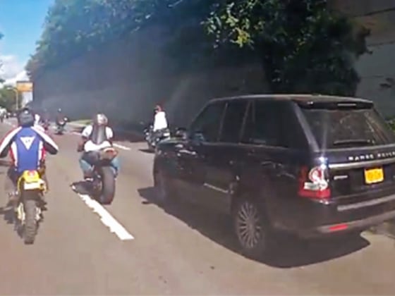Motorcylces surround Alexian Lien's Range Rover on Manhattan's West Side Highway.