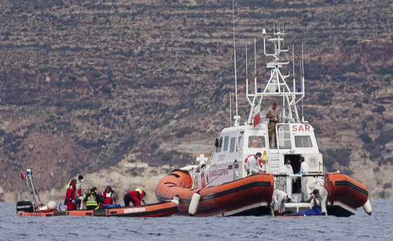 Italian Coast Guard personnel pull up a body bag on their patrol boat off the Italian island, Lampedusa, where a boat carrying migrants went down last week.