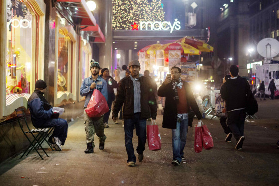 Shoppers carry bags as they leave Macy's in New York in this Nov. 23, 2012, file photo. This year, Macy's said it will open most of its stores on Thanksgiving for the first time.