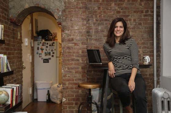 Mishelle Farer poses for a picture on Oct. 10, 2013, in her Brooklyn apartment, where she rents a room on Airbnb.