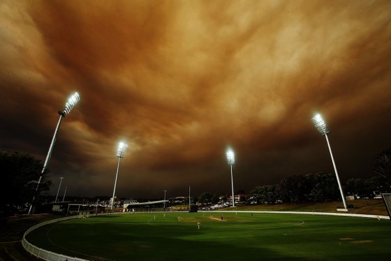 Haze dominates the sky above a cricket match between the South Australian Redbacks and the Western Australia Warriors at Drummoyne Oval in Sydney.