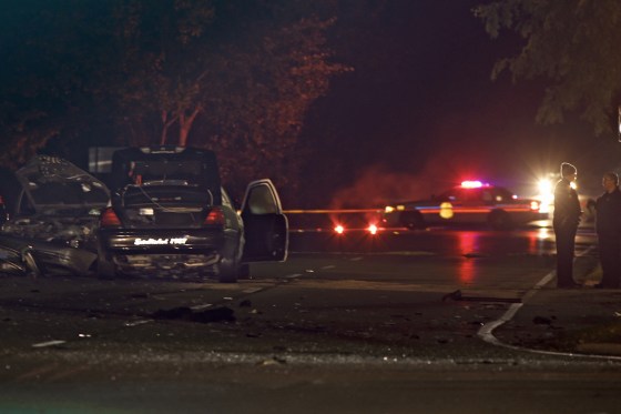 Police investigate the scene of a collision between a car and a police cruiser in Upper Arlington, Ohio, early Friday.