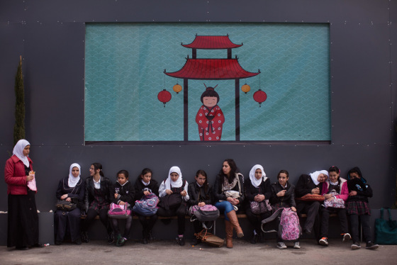Israeli Arab schoolchildren sit on a bench on in Jerusalem, Israel.