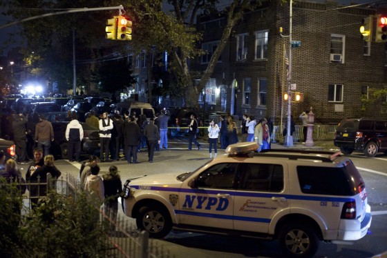 A New York Police Department vehicle stands near the scene of a stabbing rampage in Brooklyn that left five dead, including four children.