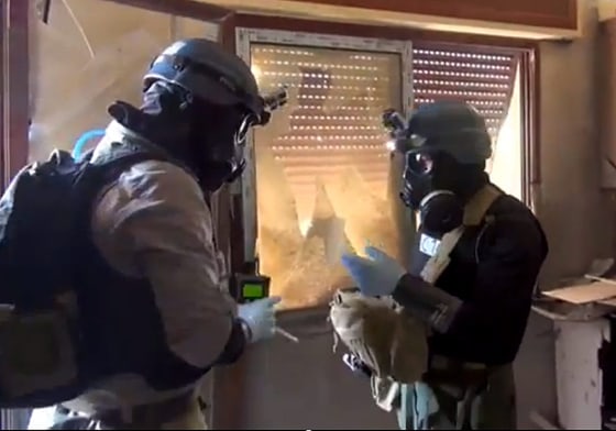 A file photo of a citizen journalism handout image provided by the Local Committee of Arbeen is said to show U.N. weapons inspectors collecting samples during investigations in Syria in August.