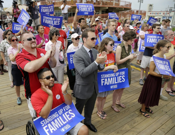 People applaud Wednesday, July 24, 2013, during a large gathering on the boardwalk in Asbury Park, N.J., as the New Jersey United for Marriage campaign announced that several national groups that support recognizing same-sex marriage are teaming up in New Jersey, saying that the state is primed to allow gay couples to wed.