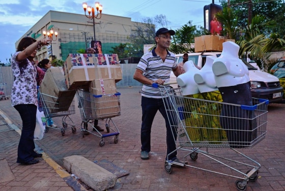 Shop owners cart of some of their goods from Westgate Mall on Monday in Nairobi.