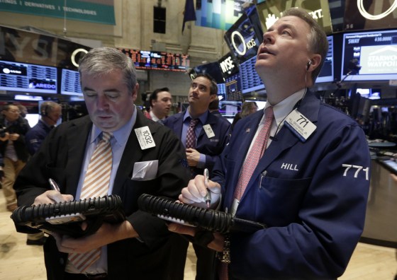 Trader Edward McCarthy, left, and F. Hill Creekmore, right, work on the floor of the New York Stock Exchange Tuesday, Feb. 4, 2014. Stocks are mixed o...