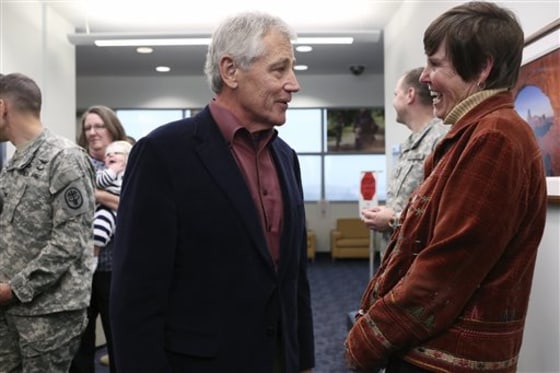 FILE - In this Wednesday, Jan. 8, 2014, file photo, U.S. Secretary of Defense Chuck Hagel talks with retired Army Col. Rebecca Hooper, program manager for the Center for the Intrepid, after Hagel spoke to soldiers, veterans and staff at the center in San Antonio. Hagel is making a rare visit to an Air Force nuclear missile base, on Thursday, hoping to boost morale among the Air Force men and women who operate, maintain and safeguard the nation's Minuteman 3 nuclear missiles, and who officials have said are increasingly tired of working in what can seem like oblivion. (AP Photo/The San Antonio Express-News, Lisa Krantz, File)